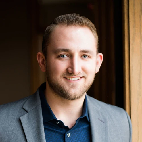 Chiropractor-Papillion-NE-Justin-Brazda-Smiling-at-Patients.webp